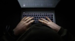 A person types on a keyboard in a dark room in this generic image. (Source: Getty Images)