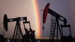 A rainbow appears to come down on pumpjacks drawing out oil and gas from wells near Calgary, Alta., Monday, Sept. 18, 2023. (THE CANADIAN PRESS/Jeff McIntosh)