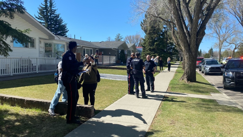 Police and paramedics speak with residents in Meadowlark Park after two dogs attacked five people the afternoon of May 9, 2024. (Miriam Valdes-Carletti/CTV News Edmonton)