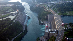 The Robert Moses-Robert H. Saunders Power Dam, built cooperatively by the New York Power Authority and Ontario Hydro along the Niagara River, as seen from the air in Lewiston, N.Y., Thursday, Aug. 14, 2003. Ontario is on the left and New York is on the right. (AP Photo/David Duprey) 