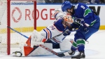 Edmonton Oilers goalie Stuart Skinner stops a shot by incoming Vancouver Canucks Conor Garland during Game 1 of their second-round NHL playoff series in Vancouver on May 8, 2024. (Darryl Dyck/The Canadian Press)