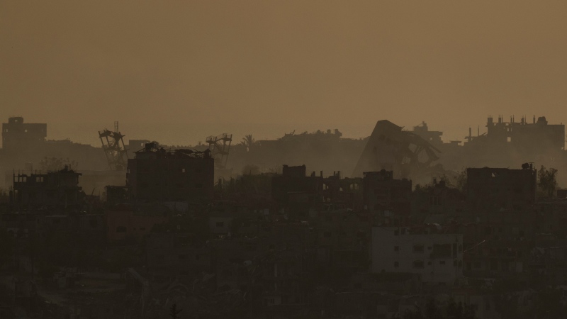 Destroyed buildings in the Gaza Strip are seen during the sunset from southern Israel, Thursday, May 9, 2024. (AP Photo/Leo Correa)