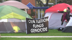 A sign at an encampment at the University of Alberta in Edmonton on May 10, 2024, condemning the war in Gaza and calling on the school to divest from Israel reads, "Our tuition funds genocide." (Brandon Lynch / CTV News Edmonton) 