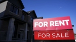 For rent and for sale signs are displayed on a house in a new housing development in Ottawa on Friday, Oct. 14, 2022. (Sean Kilpatrick / The Canadian Press)