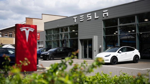 Cars are parked at a Tesla dealership in Berlin Tuesday, April 23, 2024. (Sebastian Christoph Gollnow / dpa via AP)