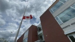 The flag at half mast outside Granite Ridge Education Centre. 16-year-old Alex Cryer died and five other students were injured in a single-vehicle crash on Burke Settlement Road near Sharbot Lake, Ont. on Thursday, May 10, 2024. (CTV News Ottawa)