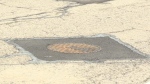 Car vs. manhole cover 