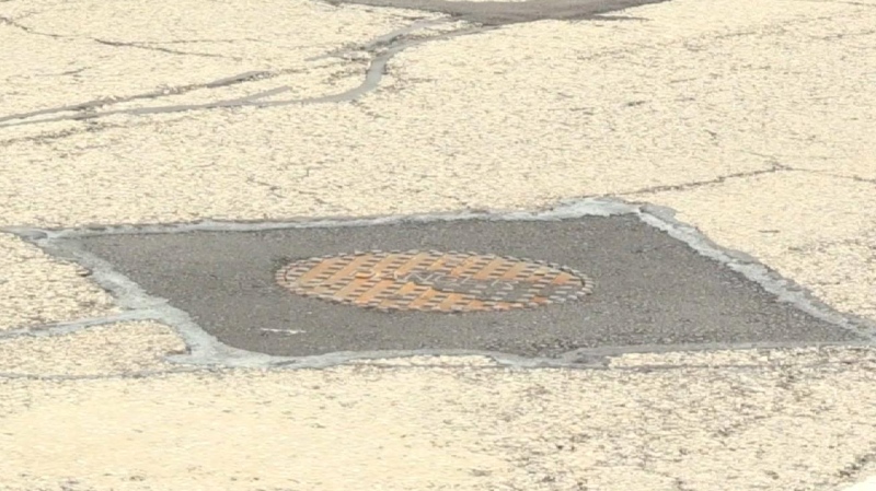Car vs. manhole cover 