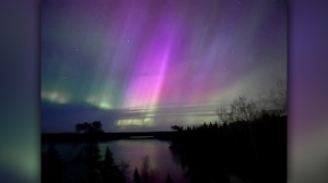  Northern lights over Caddy lake. Photo by Lora Dobson. 