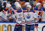 Edmonton Oilers forwards Connor McDavid and Zach Hyman celebrate McDavid's tying goal against the Vancouver Canucks during Game 2 on Friday, May 10, 2024. THE CANADIAN PRESS/Darryl Dyck