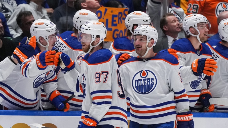 Edmonton Oilers forwards Connor McDavid and Zach Hyman celebrate McDavid's tying goal against the Vancouver Canucks during Game 2 on Friday, May 10, 2024. THE CANADIAN PRESS/Darryl Dyck
