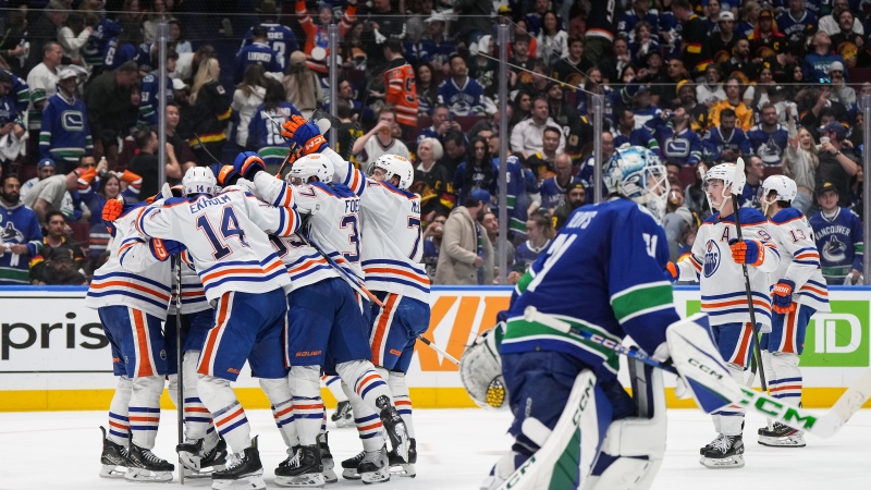 Edmonton Oilers players celebrate Evan Bouchard's winning goal against the Vancouver Canucks in Game 2 on Friday, May 10, 2024. THE CANADIAN PRESS/Darryl Dyck
