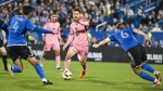 Inter Miami's Lionel Messi (10) pushes forward as CF Montreal's Fernando Alvarez (4) and Samuel Piette (6) defend during first half MLS soccer action against CF Montreal in Montreal, Saturday, May 11, 2024. (Graham Hughes, The Canadian Press)