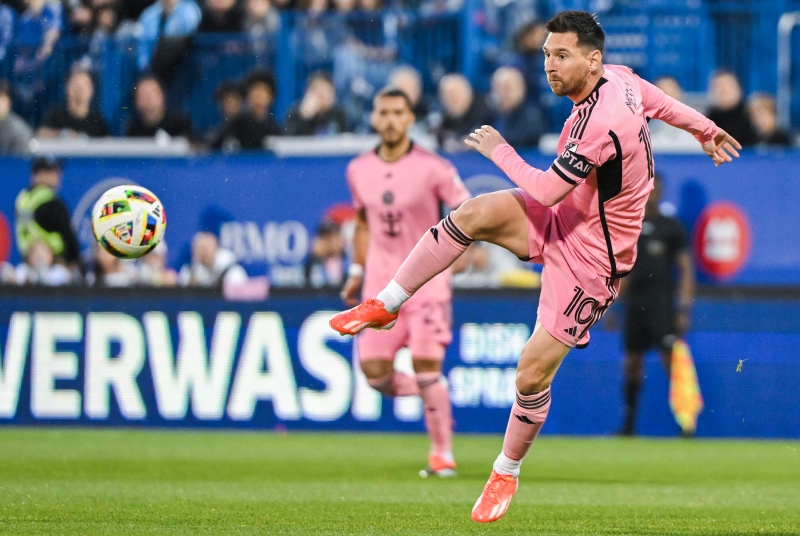 Inter Miami's Lionel Messi plays a pass during first half MLS soccer action against CF Montreal in Montreal, Saturday, May 11, 2024. (Graham Hughes, The Canadian Press)