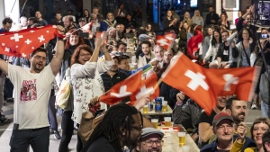 Supporters of singer Nemo, finalist of the 68th Eurovision Song Contest ESC, celebrate during a public viewing watching the broadcast of the ESC finals as Nemo is declared winner of the competition, in the early hours of Sunday, May 12, 2024, in Biel, Switzerland.  (Adrian Reusser/Keystone via AP)