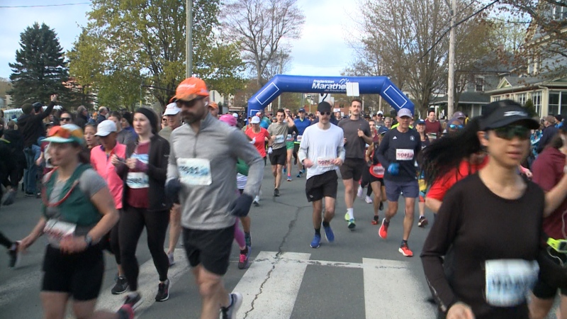 Marathon runners run past the start of the Fredericton Marathon. (CTV/Laura Brown) 
