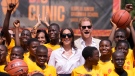 Prince Harry and Meghan, center, pose for a photograph with children during the Giant of Africa Foundation at the Dream Big Basketball clinic in Lagos Nigeria, Sunday, May 12, 2024.  (AP Photo/Sunday Alamba)