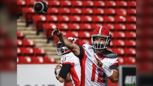 Calgary Stampeders quarterback Jake Maier, right, throws a pass during opening day of training camp in Calgary, Alta., Sunday, May 12, 2024. THE CANADIAN PRESS/Jeff McIntosh