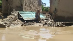 A man sits near his damaged home in Baghlan, Afghanistan on May 12, 2024. (Uncredited AP Photo)