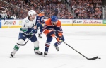 Vancouver Canucks' Brock Boeser (6) chases Edmonton Oilers' Leon Draisaitl (29) during second period second-round NHL playoff action in Edmonton, Sunday, May 12, 2024. THE CANADIAN PRESS/Jason Franson