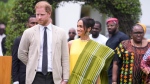 Prince Harry, left, and Meghan, right, holding hands upon arrival at the government house in Lagos Nigeria, Sunday, May 12, 2024. (AP Photo/Sunday Alamba)
