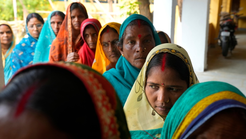 Women stand in a queue to cast their votes during the fourth phase of general election, on the outskirts of Samastipur, in the Indian state of Bihar, Monday, May 13, 2024. (AP Photo/Manish Swarup)