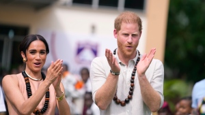Prince Harry and Meghan gesture as they visit children at the Lights Academy in Abuja, Nigeria, May 10, 2024(Sunday Alamba / AP Photo)