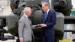 King Charles III officially hands over the role of Colonel-in-Chief of the Army Air Corps to Prince William, The Prince of Wales in front of an Apache helicopter at the Army Aviation Centre in Middle Wallop, England, Monday, May 13, 2024. (AP Photo/Kin Cheung, Pool)