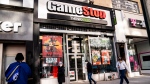 FILE: Pedestrians pass a GameStop store on Thursday, Jan. 28, 2021, in the Manhattan borough of New York. (John Minchillo / The Associated Press)