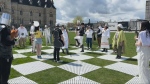 Human chessboard takes over Parliament Hill