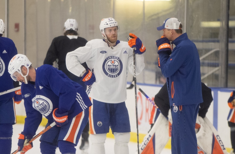 Edmonton Oilers captain Connor McDavid chats with head coach Kris Knoblauch during practice on May 7, 2024, in Edmonton. (Jason Franson/The Canadian Press)