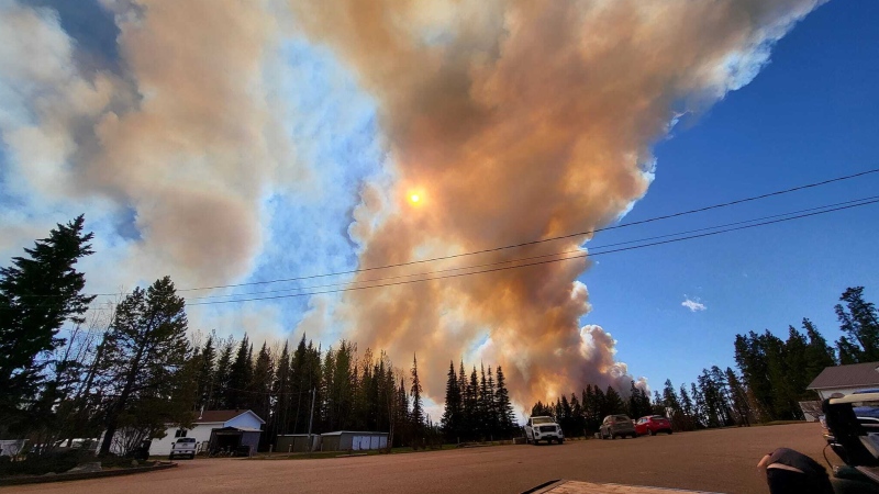Smoke rises from a wildfire burning near Fort Nelson B.C. in May 2024. (Cheyenne Berreault/Submitted)