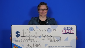 Kandice Gignac, of Midland, Ont., holds her big cheque after winning the Big Spin on May 7, 2024. (Source: OLG)