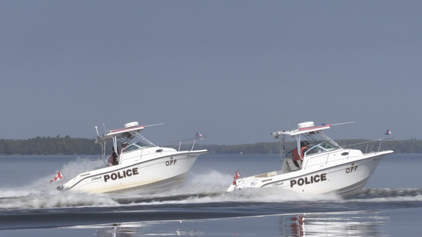 OPP officers on the water in Gravenhurst, Ont. (CTV News/Catalina Gillies)