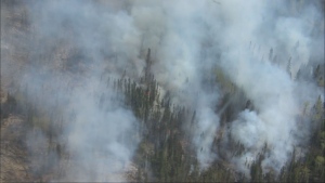 An aerial photo shows a wildfire burning near Cranberry Portage in northern Manitoba on May 14, 2024. (Pool camera)