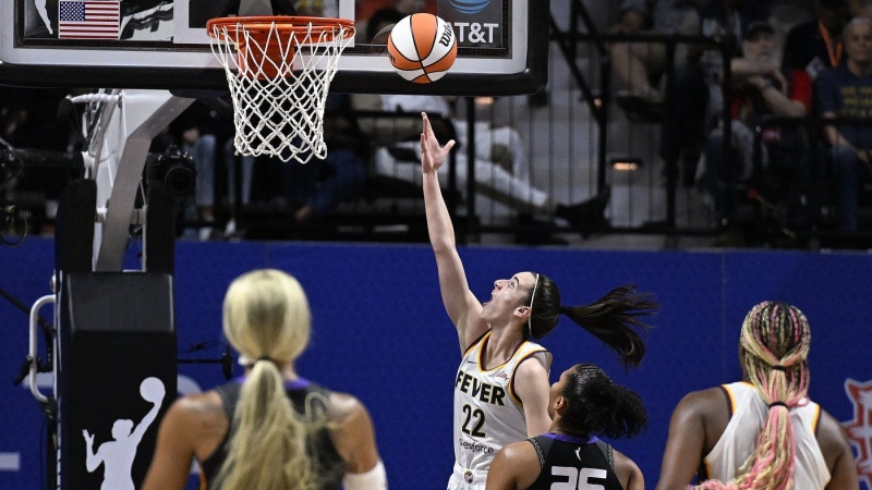 Indiana Fever guard Caitlin Clark (22) scores her first career basket against the Connecticut Sun on May 14, 2024. (Jessica Hill/AP Photo)