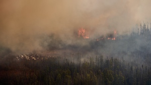A wildfire burns in northern Manitoba near near Flin Flon, as seen from a helicopter surveying the situation, Tuesday, May 14, 2024. THE CANADIAN PRESS/David Lipnowski