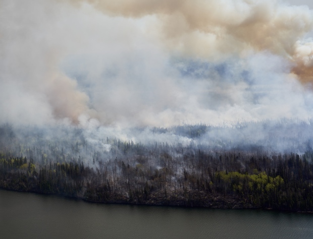 A wildfire burns in northern Manitoba near near Flin Flon, as seen from a helicopter surveying the situation, Tuesday, May 14, 2024. THE CANADIAN PRESS/David Lipnowski
