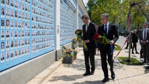 Ukraine's Foreign Minister Dmytro Kuleba, left, and U.S. Secretary of State Antony Blinken lay flowers at a memorial for fallen soldiers in Kyiv, Ukraine, Wednesday, May 15, 2024. (AP Photo/Efrem Lukatsky) 