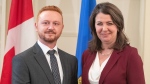 Alberta Premier Danielle Smith and Justice Minister Mickey Amery stand together during the swearing in of her cabinet in Edmonton on Friday, June 9, 2023. Amery says a new justice plan is earning support throughout the government. THE CANADIAN PRESS/Jason Franson