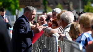 Slovakia's Prime Minister Robert Fico, centre, speaks with people before the cabinet's away-from-home session in the town of Handlova, Slovakia, Wednesday, May, 15, 2024. (Radovan Stoklasa/TASR via AP)