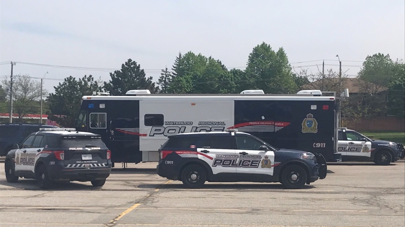 Waterloo Regional Police Service vehicles parked in a parking lot near Fischer-Hallman Road and Highland Road in Kitchener on May 15, 2024 while officers continue searching for a missing senior. (Chris Thomson/CTV News)