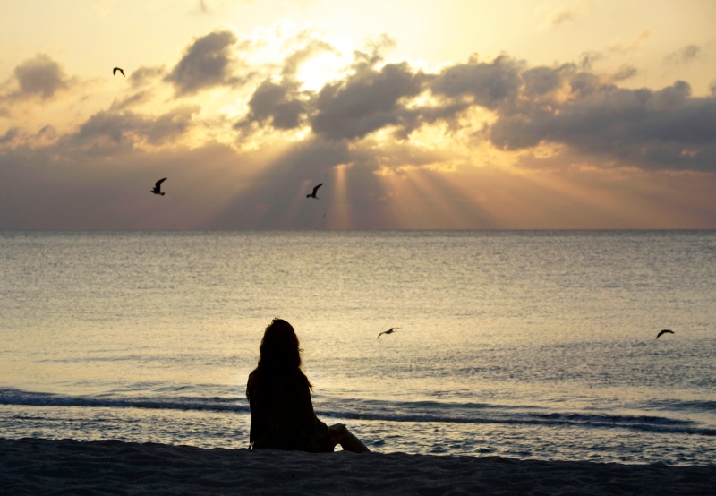 A woman meditates on the beach in Miami Beach, Fla., on April 28, 2010.  (AP Photo/Lynne Sladky, File)