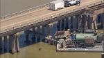 Oil spills into the surrounding waters after a barge hit a bridge in Galveston, Texas, on Wednesday, May 15, 2024. (KTRK via AP)