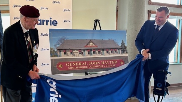 General John Hayter (L) and Barrie Mayor Alex Nuttall (R unveiling a painting to commemorate the renaming of the Southshore Community Centre in Barrie, Ont., on Wed., May 15, 2024. (CTV News/Mike Lang)