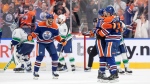 From left, Edmonton Oilers players Evander Kane, Dylan Holloway and Evan Bouchard celebrate Bouchard's goal on May 14, 2024, against the Vancouver Canucks. The goal won the game for the Oilers, tying the second-round NHL playoff series at two games each. (Jason Franson/The Canadian Press)