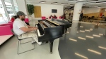 Archie Gould, a local painter, shows off his piano skills at the Stanley A. Milner Library. (Amanda Anderson/CTV News Edmonton)