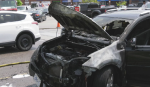 The charred remains of an SUV sit in a parking lot after a fire in Waterloo near University Ave West and Weber Street North on May 15, 2024. (Dave Pettitt/CTV News)