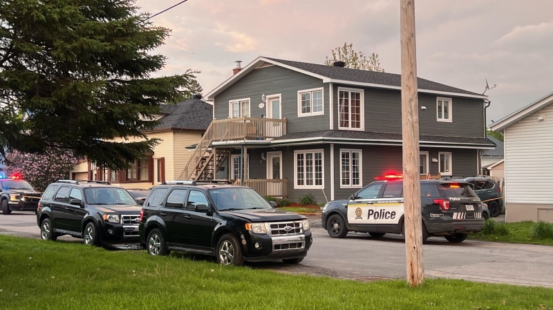 Police vehicles are parked outside of a home in Ormstown, Que., after a woman was found stabbed to death on Wednesday, May 15, 2024. (Cosmo Santamaria/CTV News)