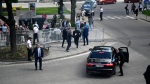 Bodyguards take Slovak Prime Minister Robert Fico in a car from the scene after he was shot and injured following the cabinet's away-from-home session in the town of Handlova, Slovakia, Wednesday, May 15, 2024. Fico is in life-threatening condition after being wounded in a shooting Wednesday afternoon, according to his Facebook profile. (Radovan Stoklasa/TASR via AP)
